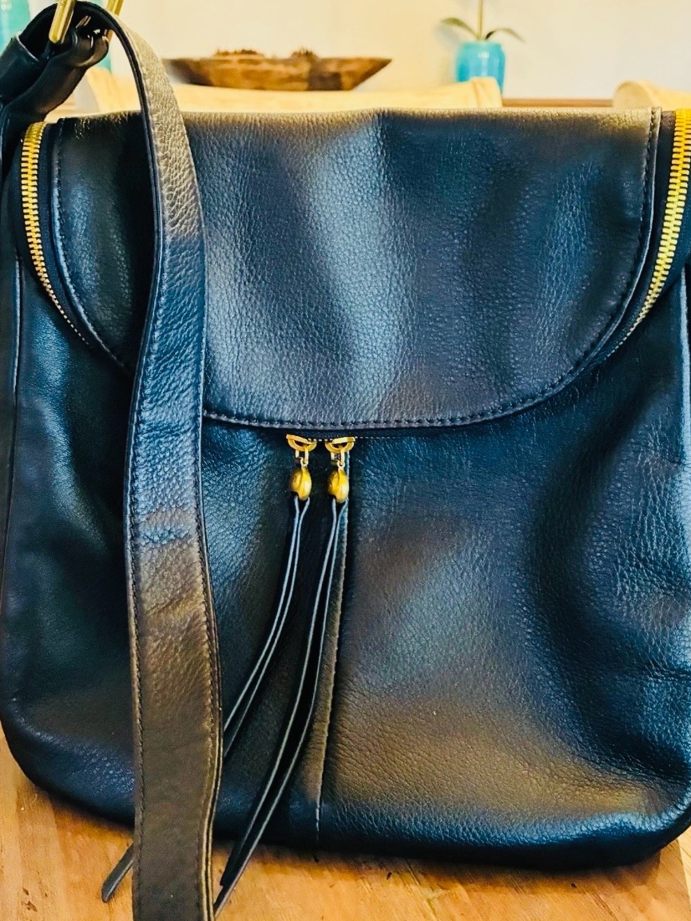 Hobo brand Zip Flap crossbody black pebble leather with gold hardware.